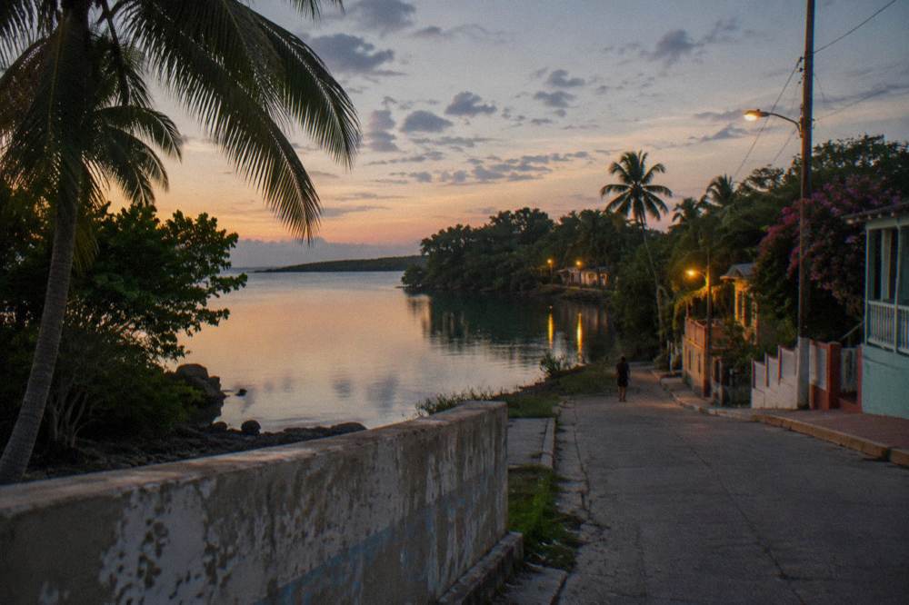 Calm sheltered lagoon at twilight with tree lined shore and still reflective water
