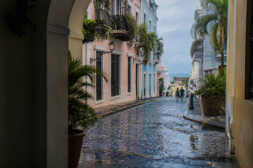 Pastel-colored colonial buildings along a cobblestone street in Old San Juan