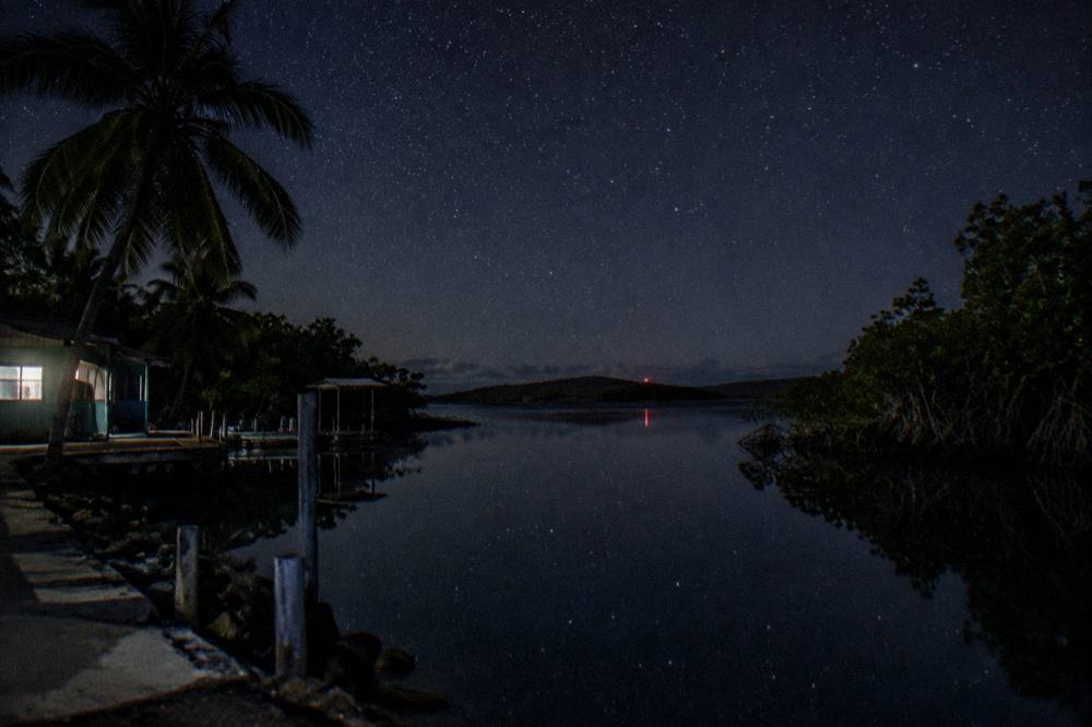 Dark night sky over calm lagoon water at Laguna Grande